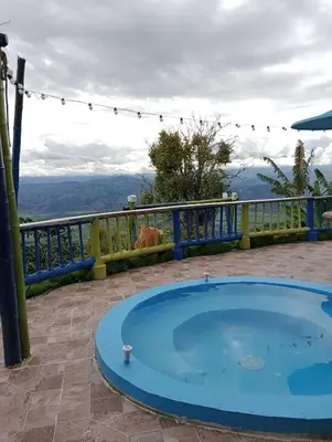 a hot tub on a patio with a view at Cabaña Villa Lucía in El Madroño