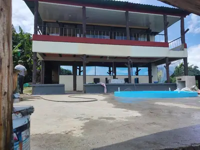 a man standing in front of a building at Cabaña Villa Lucía in El Madroño