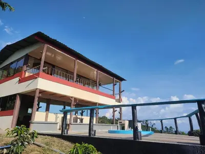 a large building with a balcony on top of it at Cabaña Villa Lucía in El Madroño