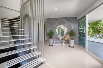 a hallway with a staircase and potted plants at Aurora Ecoliving Finca a 30 minutos de Medellín in Girardota
