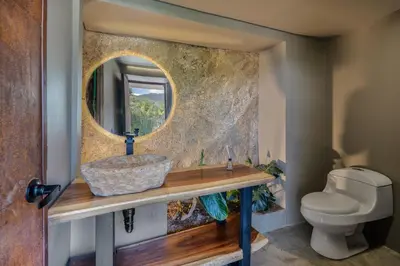 a bathroom with a sink and a mirror at Aurora Ecoliving Finca a 30 minutos de Medellín in Girardota