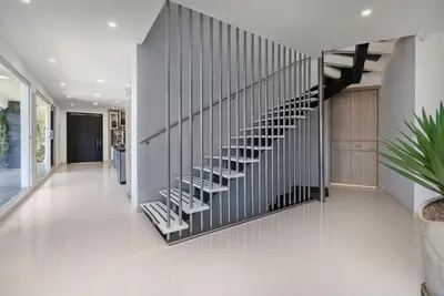 a hallway with a spiral staircase in a house at Aurora Ecoliving Finca a 30 minutos de Medellín in Girardota