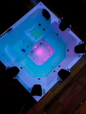 a bath tub with a purple light in it at Hostel43 in Estación El Salto