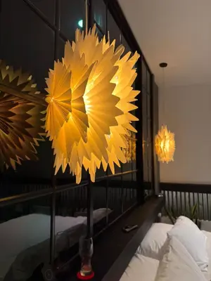 a bedroom with a mirror with a yellow flower on it at Hostel43 in Estación El Salto