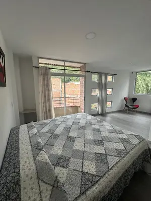 a bedroom with a large bed and a large window at La terraza 2 in Ciudad Bolívar