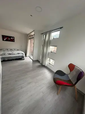 a bedroom with a bed and a chair in it at La terraza 2 in Ciudad Bolívar