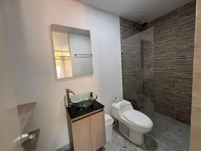 a bathroom with a toilet and a sink and a mirror at La terraza 2 in Ciudad Bolívar
