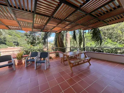 a patio with a table and chairs on a balcony at La terraza 2 in Ciudad Bolívar