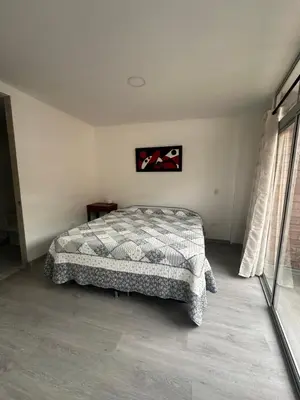 a bedroom with a bed in a white room at La terraza 2 in Ciudad Bolívar