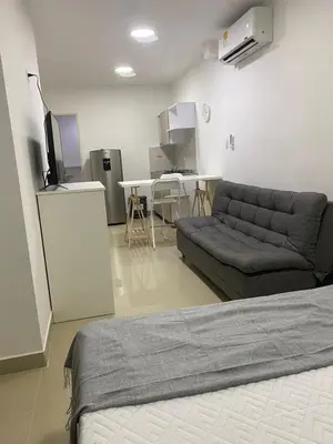 a living room with a couch and a television at Apartahotel Provenza 2 in Medellín
