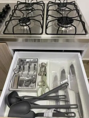a drawer in a stove with some cooking utensils at Apartahotel Provenza 2 in Medellín
