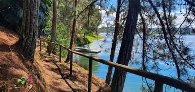 a view of a river with a boat in the water at El Trebol in Guatapé