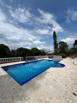 a swimming pool with blue water in a yard at Hacienda San Rafael en Jericó, Antioquia in Jericó