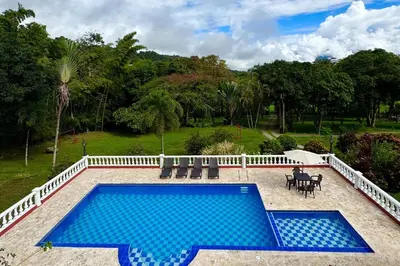 a swimming pool with blue tiles on a patio at Hacienda San Rafael en Jericó, Antioquia in Jericó