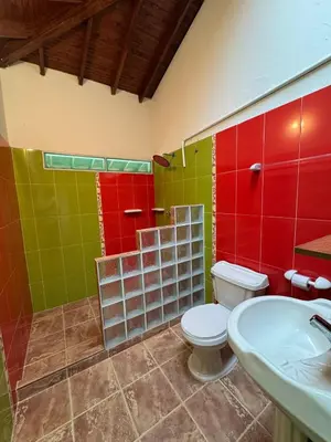 a bathroom with a toilet and a sink at Hacienda San Rafael en Jericó, Antioquia in Jericó