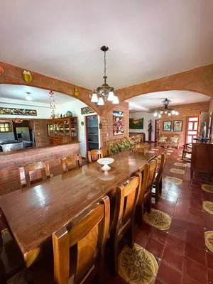 a large dining room with a long table and chairs at Hacienda San Rafael en Jericó, Antioquia in Jericó