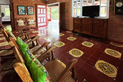 a room with chairs and a flat screen tv at Hacienda San Rafael en Jericó, Antioquia in Jericó
