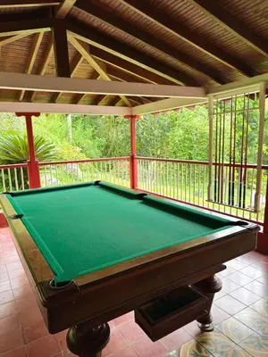 a pool table on a screened in porch at Hacienda San Rafael en Jericó, Antioquia in Jericó