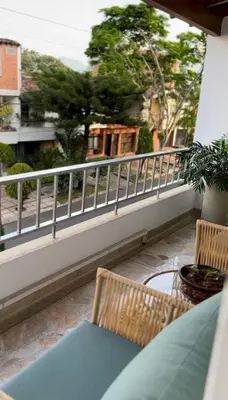 a balcony with a table and chairs and a railing at Casa Laurel Hospedaje Boutique Alojamiento Completo in Medellín