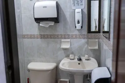 a bathroom with a white toilet and a sink at Casa Laurel Hospedaje Boutique Alojamiento Completo in Medellín