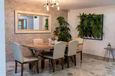 a dining room with a table and chairs and a mirror at Casa Laurel Hospedaje Boutique Alojamiento Completo in Medellín