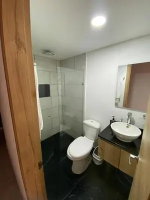 a bathroom with a white toilet and a sink at Apartaestudio GoldensMary Buenos Aires in Medellín