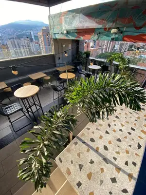 a view of a restaurant with tables and plants at Apartaestudio GoldensMary Buenos Aires in Medellín