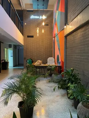 a room with plants and a couch in a building at Apartaestudio GoldensMary Buenos Aires in Medellín