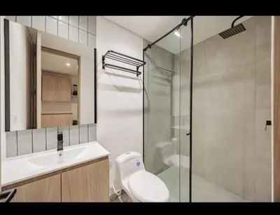 a bathroom with a shower and a toilet and a sink at NEW Loft 38 mt in Laureles, AC, Internet, Jacuzzis, 1 Queen Bed & 1 sofabed in Medellín