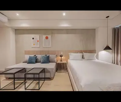 a hotel room with two beds and a couch at NEW Loft 38 mt in Laureles, AC, Internet, Jacuzzis, 1 Queen Bed & 1 sofabed in Medellín