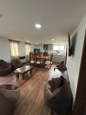 a living room with a couch and a table at Casa Campestre Los Nevados Patio Bonito in Estación El Salto