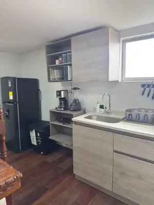 a kitchen with a sink and a black refrigerator at Casa Campestre Los Nevados Patio Bonito in Estación El Salto