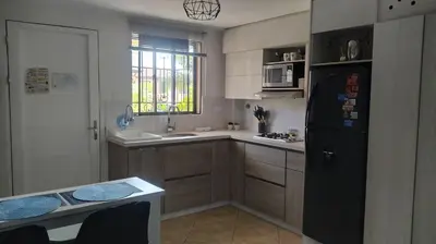 a kitchen with a black refrigerator and a sink at Amoblado en la Estrella in La Estrella