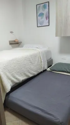 two beds sitting next to each other in a room at Amoblado en la Estrella in La Estrella