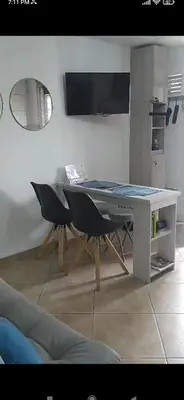 a dining room with a table and chairs and a mirror at Amoblado en la Estrella in La Estrella