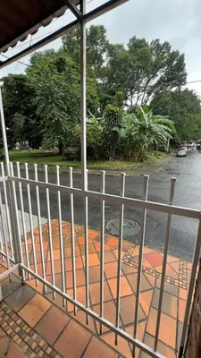 a view of a street through a fence at new apartment in front of the park in Medellín