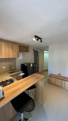 a kitchen with a counter and a counter top at new apartment in front of the park in Medellín