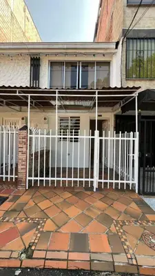 a white fence in front of a building at new apartment in front of the park in Medellín