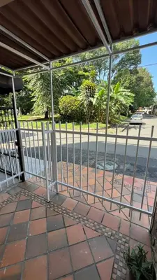 a metal fence with a view of a street at new apartment in front of the park in Medellín