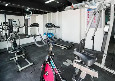 a gym with a bike and several tread machines at Cozy and Bright Studio Loft in Central Laureles in Medellín