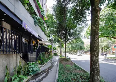 a building with a store on the side of a street at Cozy and Bright Studio Loft in Central Laureles in Medellín