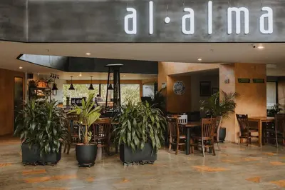a restaurant with potted plants and tables and chairs at Hotel Rioverde-Suite localizada a 5 minutos del aeropuerto Internacional in Rionegro