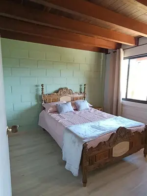 a bedroom with a wooden bed in a room at Alma Guatapé in Guatapé