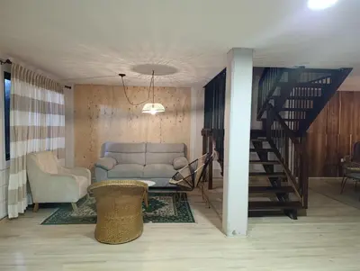 a living room with a couch and a staircase at Alma Guatapé in Guatapé