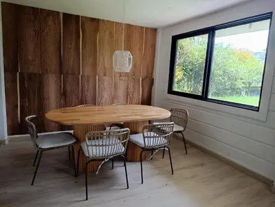 a table and chairs in a room with a window at Alma Guatapé in Guatapé