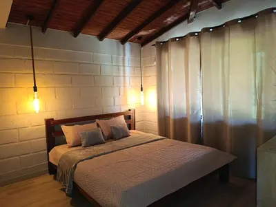 a bedroom with a bed with two pillows at Alma Guatapé in Guatapé