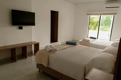 a bedroom with two beds and a flat screen tv at Sky Natural Museum in Santa Fe de Antioquia