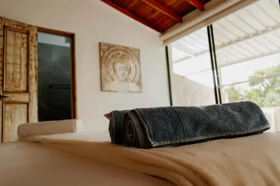 a bed with a towel sitting on top of it at Sky Natural Museum in Santa Fe de Antioquia