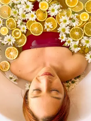 a woman laying in a pool of lemons and oranges at GUATAPE By MONTE GANDOLFO in Chiquinquirá