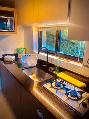 a kitchen with a sink and a stove and a window at GUATAPE By MONTE GANDOLFO in Chiquinquirá